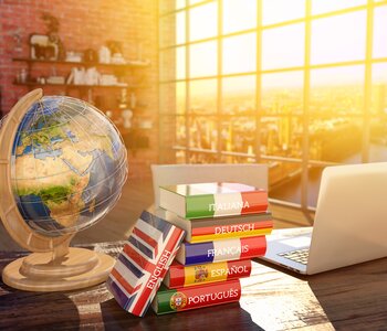 Table with globe, books and laptop