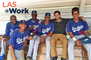 Man sitting with group of baseball players