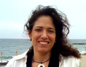 Smiling woman standing in front of the sea