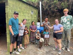 Students hand off house keys to family during volunteer trip