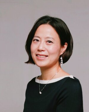 Smiling woman with short dark hair and black blouse 