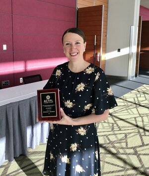 Florencia Henshaw poses with ACTFL award