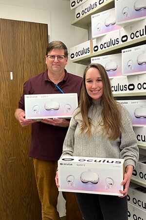 Man and woman holding virtual reality headsets