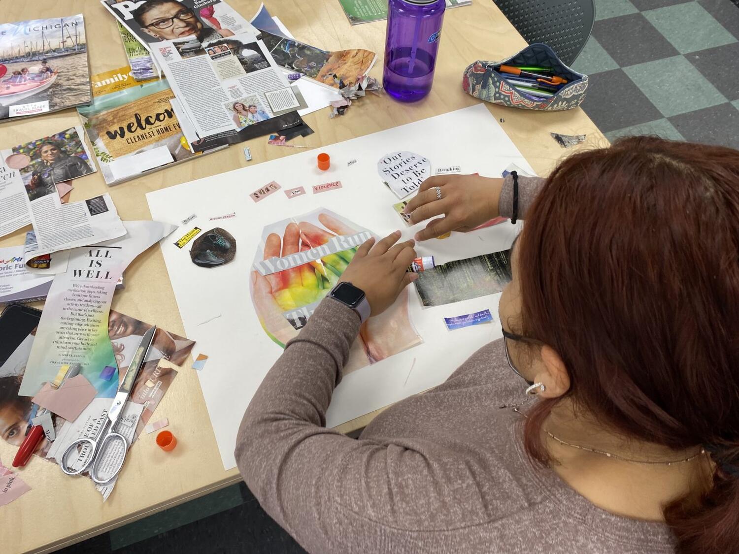 Woman works on collage at desk