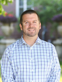 Headshot of man in plaid button down shirt