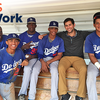 Man sitting with group of baseball players