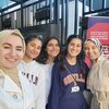 Group of four members of Arabic Debate Team and their coach 