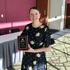 Florencia Henshaw poses with ACTFL award