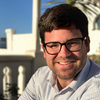 Smiling man with dark hair and glasses