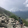 Student poses by mountain of rocks